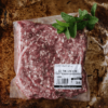 A package of Waipawa Butchery lamb mince sits on a tray with a sprig of mint on top.