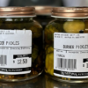 2 Jars of Waipawa Butchery Burger Pickles sit on top of the counter in the store.